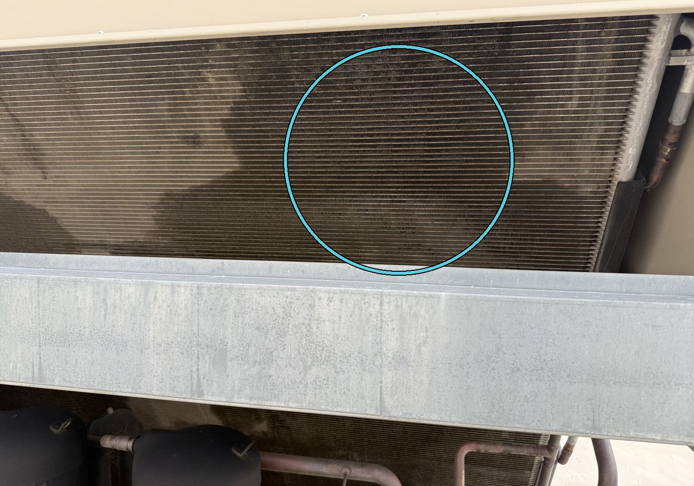 Condenser coil with dark oily staining in the center section