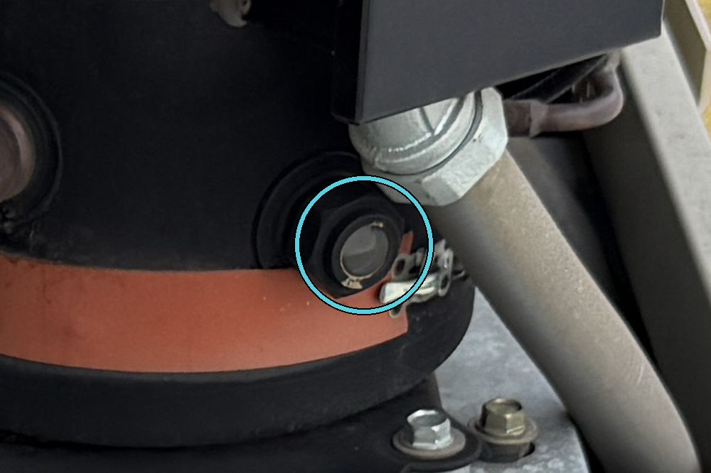 Compressor oil sight glass showing oil about halfway up